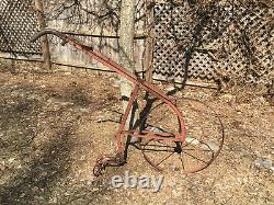 Antique iron cultivator plow walk-behind farm implement